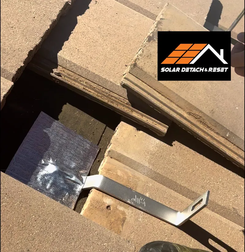 Close-up of a solar panel mounting bracket and flashed roof penetration on an Arizona tile roof