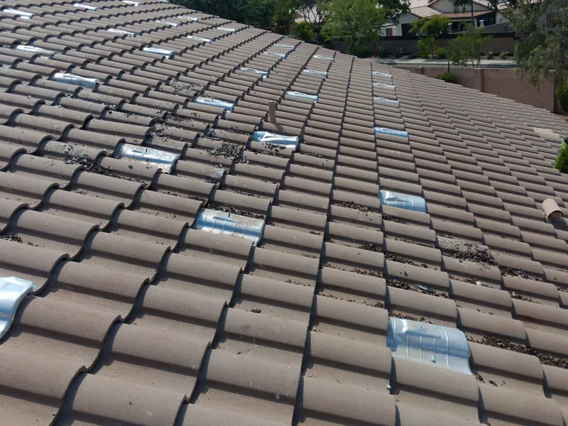 Solar mounts standing on a stripped Arizona tile roof mid re-roof, panels detached and stored