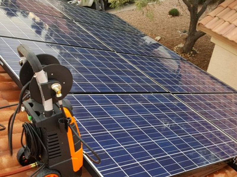 Solar panels on a rooftop with a diagnostic tool for solar system repairs, reflecting Solar Detach & Reset's licensed and insured services in Arizona.