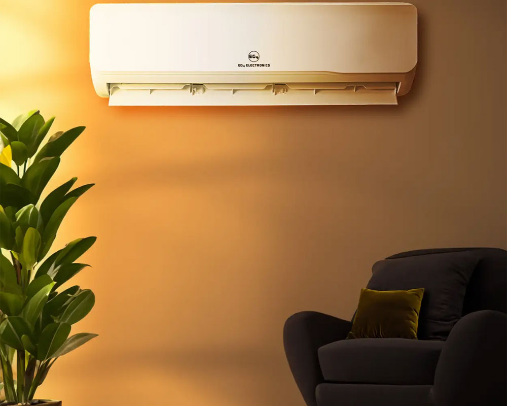 Solar-powered mini split air conditioner mounted on a wall, surrounded by a potted plant and a cozy armchair, highlighting energy-efficient cooling solutions for homes and offices.