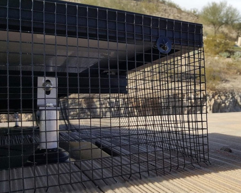 Solar panel bird guard installation with durable black mesh, preventing bird infestations and protecting solar systems in Arizona.